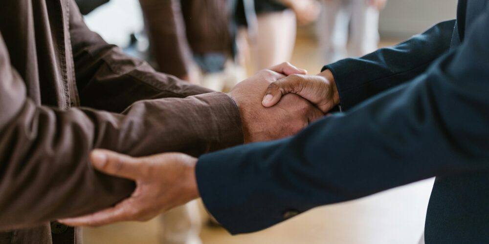 Close up photo of two men shaking hands