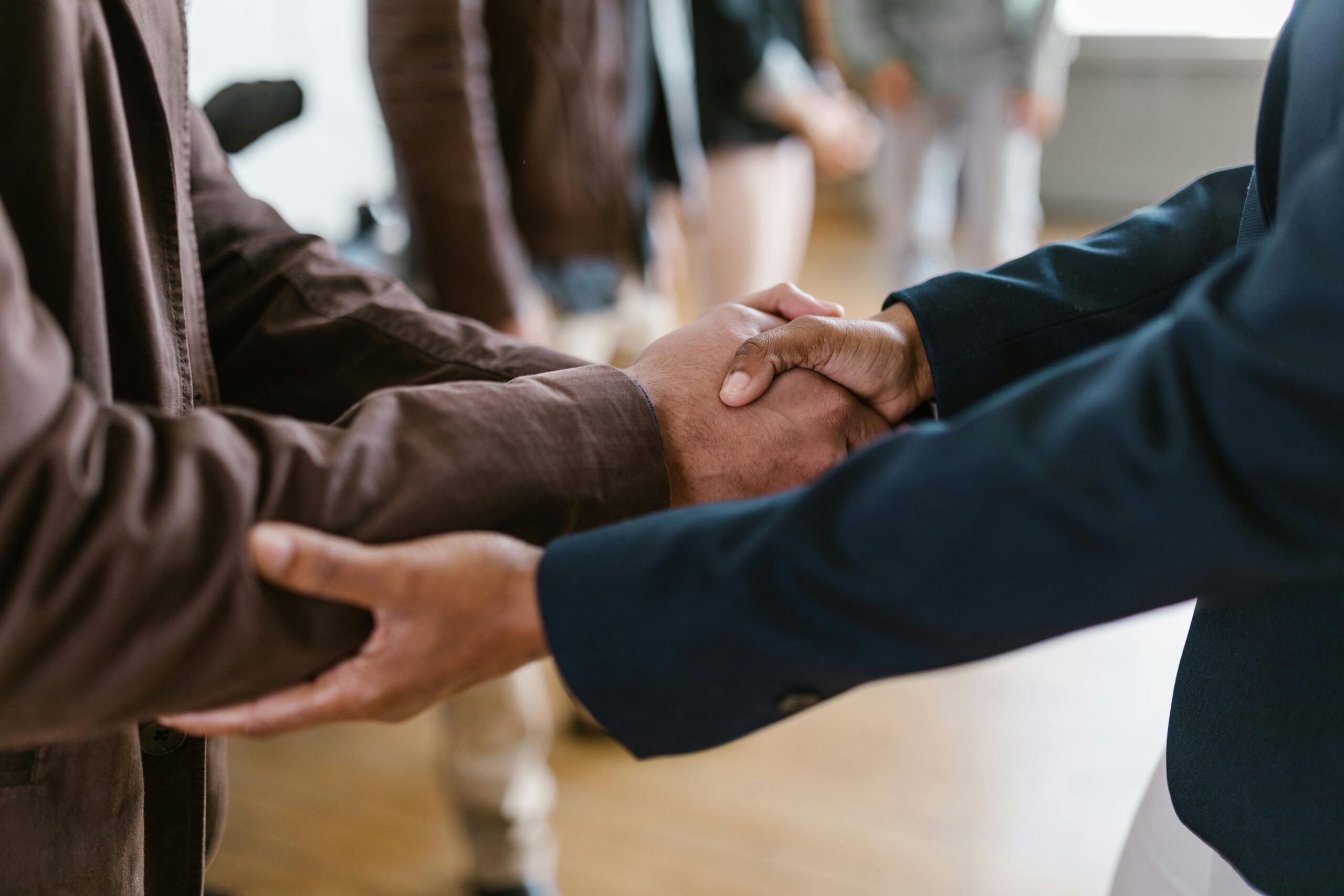 Close up photo of two men shaking hands